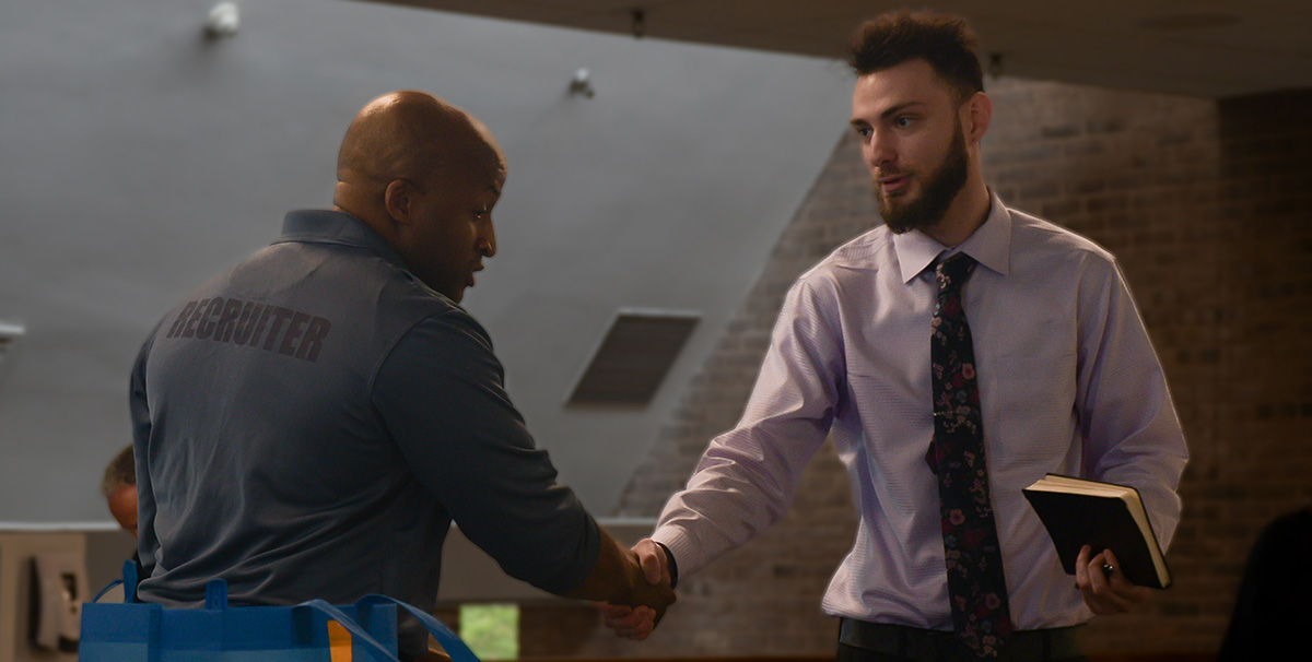 Robbie Wright shakes hands with Towson University student Jason Shank.