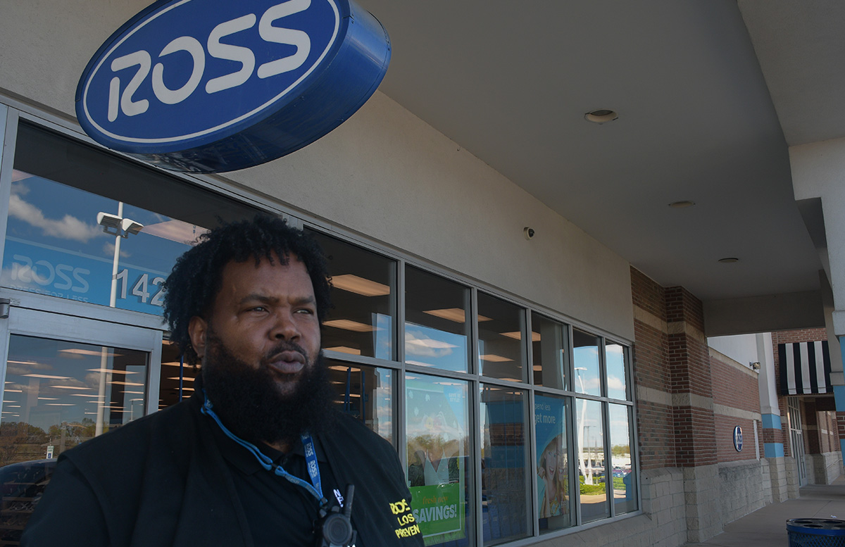 Alex Godfrey stands in front of Ross Dress For Less, looking out into the Laurel Lakes Centre parking lot on a sunny afternoon.